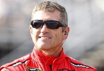 LOUDON, NH - SEPTEMBER 18:  Bobby Labonte, driver of the #71 TRG Motorsports Chevrolet, waits by his car during qualifying for the NASCAR Sprint Cup Series Sylvania 300 at the New Hampshire Motor Speedway on September 18, 2009 in Loudon, New Hampshire  (Photo by Geoff Burke/Getty Images for NASCAR)