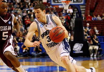 PHILADELPHIA - MARCH 19:  Jimmer Fredette #32 of the Brigham Young Cougars drives against Dash Harris #5 of the Texas A&M Aggies during the first round of the NCAA Division I Men's Basketball Tournament at the Wachovia Center on March 19, 2009 in Philadelphia, Pennsylvania.  (Photo by Jim McIsaac/Getty Images)