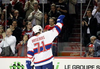 MONTREAL- MARCH 14:  Patrice Brisebois #71 of the Montreal Canadiens waves to the crowd during a play stoppage when he was honored for playing in his 1000th career NHL game at the Bell Centre on March 14, 2009 in Montreal, Quebec, Canada.  The Devils defeated the Canadiens 3-1.   (Photo by Richard Wolowicz/Getty Images)