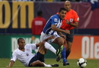 CHICAGO - JUNE 06: Amado Guevara #7 of Honduras collides with Ricardo Clark #2 of the United States as they pursue the ball during a FIFA 2010 World Cup Qualifying match on June 6, 2009 at Soldier Field in Chicago, Illinois. The United States defeated Honduras 2-1. (Photo by Jonathan Daniel/Getty Images)