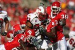 PISCATAWAY, NJ - SEPTEMBER 29: Jason McCourty #25 and Ron Girault #43 of the Rutgers Scarlet Knights tackle Da'Rel Scott #23 of the Maryland Terrapins during their game at Rutgers Stadium on September 29, 2007 in Piscataway, New Jersey. (Photo by Nick Laham/Getty Images)