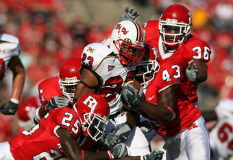 PISCATAWAY, NJ - SEPTEMBER 29: Jason McCourty #25 and Ron Girault #43 of the Rutgers Scarlet Knights tackle Da'Rel Scott #23 of the Maryland Terrapins during their game at Rutgers Stadium on September 29, 2007 in Piscataway, New Jersey. (Photo by Nick Laham/Getty Images)