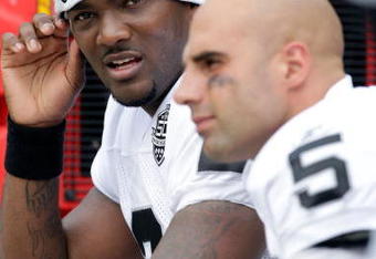 KANSAS CITY, MO - SEPTEMBER 20:  Quarterback JaMarcus Russell #2 of the Oakland Raiders talks with Bruce Gradkowski #5 on the bench during the game against the Kansas City Chiefs at Arrowhead Stadium on September 20, 2009 in Kansas City, Missouri.  (Photo by Jamie Squire/Getty Images)