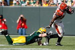 GREEN BAY, WI - SEPTEMBER 20: Running back Cedric Benson #32 of the Cincinnati Bengals runs with the football as he is grabbed by linebacker A.J. Hawk #50 of the Green Bay Packers at Lambeau Field on September 20, 2009 in Green Bay, Wisconsin. The Bengals defeated the Packers 31-24. (Photo by Scott Boehm/Getty Images)