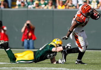 GREEN BAY, WI - SEPTEMBER 20: Running back Cedric Benson #32 of the Cincinnati Bengals runs with the football as he is grabbed by linebacker A.J. Hawk #50 of the Green Bay Packers at Lambeau Field on September 20, 2009 in Green Bay, Wisconsin. The Bengals defeated the Packers 31-24. (Photo by Scott Boehm/Getty Images)