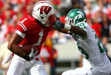 MADISON, WI - SEPTEMBER 26: Nick Toon #1 of the Wisconsin Badgers is grabbed by the facemask by Chris Rucker #29 of the Michigan State Spartans on September 26, 2009 at Camp Randall Stadium in Madison, Wisconsin. (Photo by Jonathan Daniel/Getty Images)