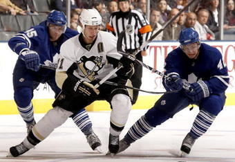 TORONTO - SEPTEMBER 22: Viktor Stahlberg #45 and Tyler Bozak #42 of the Toronto Maple Leafs hook Jordan Staal #11of the Pittsburgh Penguins during a pre-season  NHL game at the Air Canada Centre on September 22, 2009 in Toronto, Ontario, Canada.  (Photo by Abelimages/Getty Images)