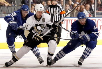 TORONTO - SEPTEMBER 22: Viktor Stahlberg #45 and Tyler Bozak #42 of the Toronto Maple Leafs hook Jordan Staal #11of the Pittsburgh Penguins during a pre-season  NHL game at the Air Canada Centre on September 22, 2009 in Toronto, Ontario, Canada.  (Photo by Abelimages/Getty Images)
