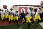 BLOOMINGTON, IN - NOVEMBER 11:  Darnell Hood #4 of the Michigan Wolverines leads the team onto the field in front of head coach Lloyd Carr for a game against the Indiana Hoosiers on November 11, 2006 at Memorial Stadium in Bloomington, Indiana. Michigan won the game 34-3.  (Photo by Gregory Shamus/Getty Images)