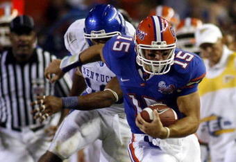 GAINESVILLE, FL - SEPTEMBER 23:  Quarterback Tim Tebow #15 of the Florida Gators breaks a tackle against the Kentucky Wildcats on September 23, 2006 at Ben Hill Griffin Stadium at Florida Field  in Gainesville, Florida. The Gators defeated the Wildcats 26 to 7.  (Photo by Marc Serota/Getty Images)