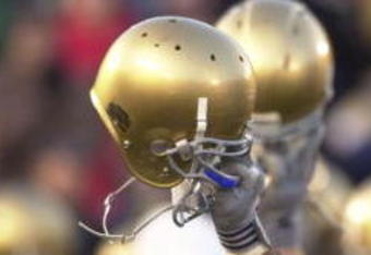 SOUTH BEND, IN - NOVEMBER 23: Members of the Notre Dame football team hold up their helmets to the student section after a game against Rutgers on November 23, 2002 at Notre Dame Stadium in South Bend, Indiana. Notre Dame defeated Rutgers 42-0. (Photo by Jonathan Daniel/Getty Images)