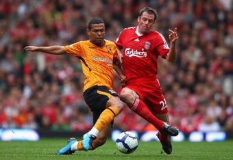 LIVERPOOL, ENGLAND - SEPTEMBER 26:  Jamie Carragher of Liverpool battles for the ball with Geovanni of Hull City during the Barclays Premier League match between Liverpool and Hull City at Anfield on September 26, 2009 in Liverpool, England. (Photo by Clive Brunskill/Getty Images)