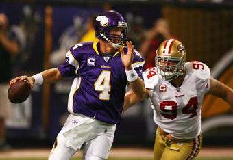 MINNEAPOLIS - SEPTEMBER 27: Brett Favre #4 of the Minnesota Vikings is chased out of the pocket by Pat Williams #94 of the San Francisco 49ers at the Hubert H. Humphrey Metrodome on September 27, 2009 in Minneapolis, Minnesota. (Photo by Jonathan Daniel/Getty Images)