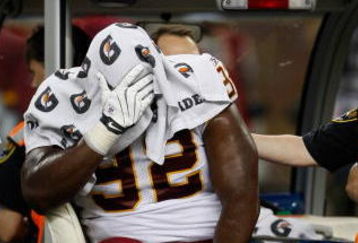 DETROIT, MI - SEPTEMBER 27: Defensive tackle Albert Haynesworth #92 of the Washington Redskins sits on a cart as he is taken off the field after an injury in the first half against the Detroit Lions at Ford Field on September 27, 2009 in Detroit, Michigan. (Photo by Scott Boehm/Getty Images)