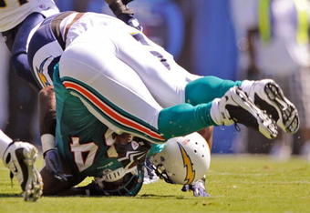 SAN DIEGO - SEPTEMBER 27:  Ronnie Brown #23 of the Miami Dolphins is hit by Kevin Burnett #99 of the San Diego Chargers after a rushing gain during first quarter of the NFL football game as at Qualcomm Stadium on September 27, 2009 in San Diego, California.  (Photo by Kevork Djansezian/Getty Images)