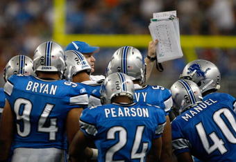 DETROIT, MI - SEPTEMBER 27: A Lions coach holds up a play to show to players during a time out during the game between the Washington Redskins  against the Detroit Lions at Ford Field on September 27, 2009 in Detroit, Michigan. The Lions defeated the Redskins 19-14. (Photo by Scott Boehm/Getty Images)