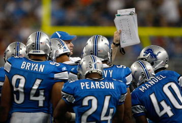 DETROIT, MI - SEPTEMBER 27: A Lions coach holds up a play to show to players during a time out during the game between the Washington Redskins  against the Detroit Lions at Ford Field on September 27, 2009 in Detroit, Michigan. The Lions defeated the Redskins 19-14. (Photo by Scott Boehm/Getty Images)
