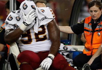 DETROIT, MI - SEPTEMBER 27: Defensive tackle Albert Haynesworth #92 of the Washington Redskins sits on a cart as he is taken off the field after an injury in the first half against the Detroit Lions at Ford Field on September 27, 2009 in Detroit, Michigan. (Photo by Scott Boehm/Getty Images)