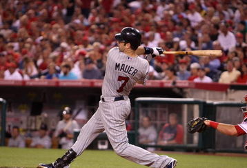 ANAHEIM, CA - JULY 24:  Joe Mauer #7 of the Minnesota Twins hits his second home run of the game in the sixth inning against the Los Angeles Angels of Anaheim on July 24, 2009 at Angel Stadium in Anaheim, California.  (Photo by Stephen Dunn/Getty Images)