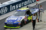 DOVER, DE - SEPTEMBER 27:  Jimmie Johnson, driver of the #48 Lowe's Chevrolet, celebrates with the checkered flag after winning the NASCAR Sprint Cup Series AAA 400 at Dover International Speedway on September 27, 2009 in Dover, Delaware. NASCAR Official Rodney Wise handed off the flag to Johnson. (Photo by Chris Trotman/Getty Images)