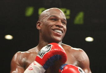 LAS VEGAS - SEPTEMBER 19:  Floyd Mayweather Jr. smiles during his fight against Juan Manuel Marquez of Mexico during their welterweight bout at the MGM Grand Garden Arena September 19, 2009 in Las Vegas, Nevada. (Photo by Ethan Miller/Getty Images)