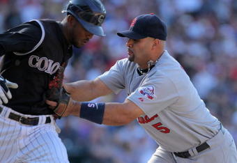 DENVER - SEPTEMBER 27:  Albert Pujols #5 of the St. Louis Cardinals gets a put out as he tags Dexter Fowler #24 of the Colorado Rockies as he lays down a sacrifice bunt at Coors Field on September 27, 2009 in Denver, Colorado. The Rockies defeated the Cardinals 4-3.  (Photo by Doug Pensinger/Getty Images)