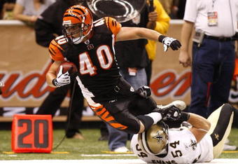 NEW ORLEANS - AUGUST 14:  Running back Brian Leonard #40 of the Cincinnati Bengals is tackled by linebacker Troy Evans #54 of the New Orleans Saints during the preseason game on August 14, 2009 at the Superdome in New Orleans, Louisiana. (Photo by Chris Graythen/Getty Images)
