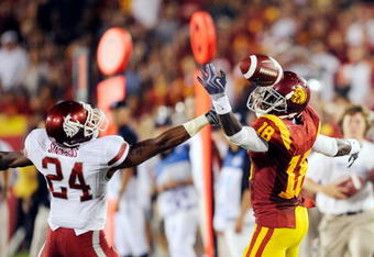 LOS ANGELES, CA - SEPTEMBER 26:  Damian Williams #18 of the USC Trojans drops a pass as he is defended by Daniel Simmons #24 of the Washington State Cougars during the first quarter of the college football game at the Los Angeles Memorial Coliseum on September 26, 2009 in Los Angeles, California.  (Photo by Kevork Djansezian/Getty Images)