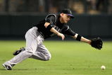 PHOENIX - SEPTEMBER 20:  Infielder Clint Barmes #12 of the Colorado Rockies is unable to field a single hit by the Arizona Diamondbacks during the major league baseball game at Chase Field on September 20, 2009 in Phoenix, Arizona. The Rockies defeated the Diamondbacks 5-1.  (Photo by Christian Petersen/Getty Images)