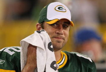 GREEN BAY, WI - SEPTEMBER 13: Aaron Rodgers #12 of the Green Bay Packers smiles at a teammate on the sidelines after throwing the winning touchdown pass against the Chicago Bears on September 13, 2009 at Lambeau Field in Green Bay, Wisconsin. The Packers defeated the Bears 21-15. (Photo by Jonathan Daniel/Getty Images)
