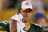 GREEN BAY, WI - SEPTEMBER 13: Aaron Rodgers #12 of the Green Bay Packers smiles at a teammate on the sidelines after throwing the winning touchdown pass against the Chicago Bears on September 13, 2009 at Lambeau Field in Green Bay, Wisconsin. The Packers defeated the Bears 21-15. (Photo by Jonathan Daniel/Getty Images)