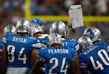 DETROIT, MI - SEPTEMBER 27: A Lions coach holds up a play to show to players during a time out during the game between the Washington Redskins  against the Detroit Lions at Ford Field on September 27, 2009 in Detroit, Michigan. The Lions defeated the Redskins 19-14. (Photo by Scott Boehm/Getty Images)