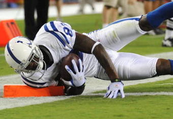 GLENDALE, AZ - SEPTEMBER 27:  Wide receiver Reggie Wayne #87 of the Indianapolis Colts dives into the endzone catching a 20-yard touchdown pass in the second quarter against the Arizona Cardinals during the game at University of Phoenix Stadium on September 27, 2009 in Glendale, Arizona. (Photo by Harry How/Getty Images)