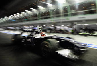 SINGAPORE - SEPTEMBER 26:  (EDITORS NOTE: A SPECIAL EFFECTS FILTER WAS USED IN THE CREATION OF THIS IMAGE) Kazuki Nakajima of Japan and Williams drives down the pitlane during final practice prior to qualifying for the Singapore Formula One Grand Prix at the Marina Bay Street Circuit on September 26, 2009 in Singapore.  (Photo by Clive Mason/Getty Images)