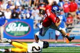 LAWRENCE, KS - SEPTEMBER 26:  Quarterback Todd Reesing #5 of the Kansas Jayhawks evades C.J. Bailey #20 of the Southern Mississippi Golden Eagles during the game on September 26, 2009 at Memorial Stadium in Lawrence, Kansas.  (Photo by Jamie Squire/Getty Images)