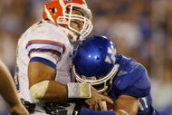 LEXINGTON, KY - SEPTEMBER 26: Quarterback Tim Tebow #15 of the Florida Gators is sacked by Taylor Wyndham #94 of the Kentucky Wildcats during the third quarter of the game at Commonwealth Stadium on September 26, 2009 in Lexington, Kentucky. (Photo by Andy Lyons/Getty Images)