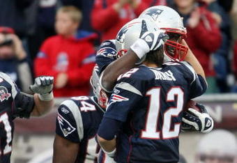 FOXBORO, MA - SEPTEMBER 27:  Tom Brady #12 of the New England Patriots celebrates the touchdown with Chris Baker #86 after Brady threw a pass to Baker for the touchdown in the fourth quarter the Atlanta Falcons on September 27, 2009 at Gillette Stadium in Foxboro, Massachusetts. The Patriots defeated the Falcons 26-10.  (Photo by Elsa/Getty Images)