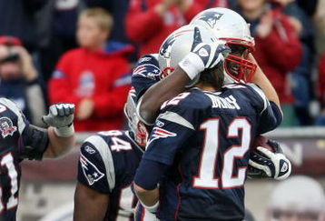 FOXBORO, MA - SEPTEMBER 27:  Tom Brady #12 of the New England Patriots celebrates the touchdown with Chris Baker #86 after Brady threw a pass to Baker for the touchdown in the fourth quarter the Atlanta Falcons on September 27, 2009 at Gillette Stadium in Foxboro, Massachusetts. The Patriots defeated the Falcons 26-10.  (Photo by Elsa/Getty Images)