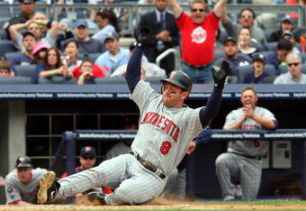 NEW YORK - MAY 17:  Nick Punto #8 of the Minnesota Twins scores a seventh inning run against the New York Yankees after a wild pitch on May 17, 2009 at Yankee Stadium in the Bronx borough of New York City.  (Photo by Jim McIsaac/Getty Images)