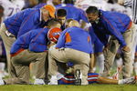 LEXINGTON, KY - SEPTEMBER 26: Quarterback Tim Tebow #15 of the Florida Gators is tended to by head coach Urban Meyer (R) and staff after Tebow was sacked by Taylor Wyndham #94 of the Kentucky Wildcats during the third quarter of the game at Commonwealth Stadium on September 26, 2009 in Lexington, Kentucky. (Photo by Andy Lyons/Getty Images)