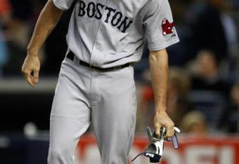 NEW YORK - SEPTEMBER 26: Josh Reddick #68 of the Boston Red Sox drops his gloves into his helmet after striking out looking during the game against the New York Yankees on September 26, 2009 at Yankee Stadium in the Bronx borough of New York City.  (Photo by Jared Wickerham/Getty Images)