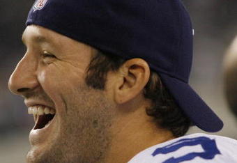 ARLINGTON, TX - AUGUST 21:  Quarterback Tony Romo #9 of the Dallas Cowboys laughs with teammates in the fourth quarter against the Tennessee Titans during a preseason game at Dallas Cowboys Stadium on August 21, 2009 in Arlington, Texas. (Photo by Tom Pennington/Getty Images) 