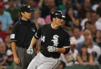 BOSTON - AUGUST 26:  Paul Konerko #14 of the Chicago White Sox  makes a RBI triple in the first inning during the game against the Boston Red Sox on August 26, 2009 at Fenway Park in Boston, Massachusetts. (Photo by: Elsa/Getty Images)