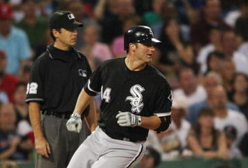 BOSTON - AUGUST 26:  Paul Konerko #14 of the Chicago White Sox  makes a RBI triple in the first inning during the game against the Boston Red Sox on August 26, 2009 at Fenway Park in Boston, Massachusetts. (Photo by: Elsa/Getty Images)