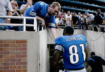 DETROIT, MI - SEPTEMBER 27:  Wide receiver Calvin Johnson #81 of the Detroit Lions celebrates with a fan as he walks off the field after the victory against the Washington Redsklns at Ford Field on September 27, 2009 in Detroit, Michigan. The Lions defeated the Redskins 19-14. (Photo by Scott Boehm/Getty Images)