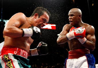 LAS VEGAS - SEPTEMBER 19:  Juan Manuel Marquez (L) and Floyd Mayweather Jr. battle in the ninth round of their fight at the MGM Grand Garden Arena September 19, 2009 in Las Vegas, Nevada. Mayweather won by unanimous decision.  (Photo by Ethan Miller/Getty Images)