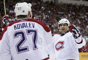 RALEIGH, NC - APRIL 22:  Alex Kovalev #27 of the Montreal Canadiens is congratulated by teammate Tomas Plekanec #35 after Kovalev scored a goal in the second period against the Carolina Hurricanes in game one of the Eastern Conference Quarterfinals during the 2006 NHL Playoffs at RBC Center on April 22, 2006 in Raleigh, North Carolina.  (Photo by Doug Benc/Getty Images)