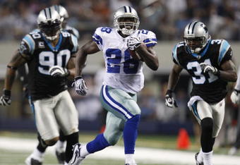 ARLINGTON, TX - SEPTEMBER 28: Felix Jones #28 of the Dallas Cowboys runs the ball 40 yards in the 3rd quarter against Richard Marshall #31 and Julius Peppers #90 of the Carolina Panthers at Cowboys Stadium on September 28, 2009 in Arlington, Texas. (Photo by Ronald Martinez/Getty Images)