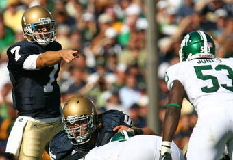 SOUTH BEND, IN - SEPTEMBER 19: Jimmy Clausen #7 of the Notre Dame Fighting Irish points out a defensive alingment including Greg Jones #53 of the Michigan State Spartans on September 19, 2009 at Notre Dame Stadium in South Bend, Indiana. Notre Dame defeated Michigan State 33-30. (Photo by Jonathan Daniel/Getty Images)