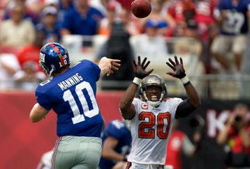 TAMPA, FL - SEPTEMBER 27:  Defensive back Ronde Barber #20 of the Tampa Bay Buccaneers tries to deflect the pass of quarterback Eli Manning #10 of the New York Giants during the game at Raymond James Stadium on September 27, 2009 in Tampa, Florida.  (Photo by J. Meric/Getty Images)